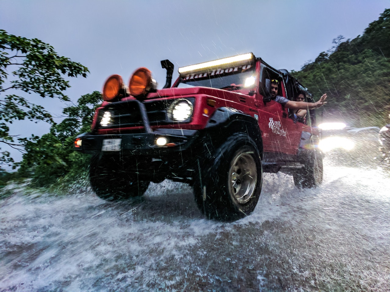 Digital nomads driving through storm in their offroad overlanding Jeep